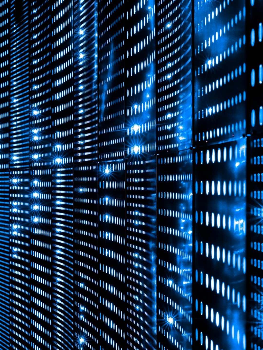 Abstract blue lights on a dark technological grid surface.